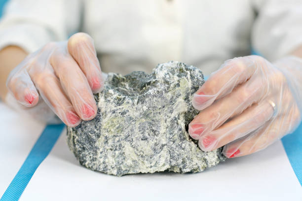 istock Female hands hold the dangerous mineral asbestos. 1073137414