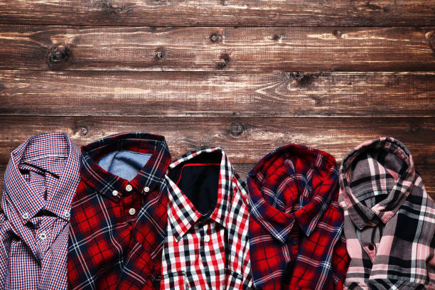 istock Colorful shirts on brown wooden table 1073137448