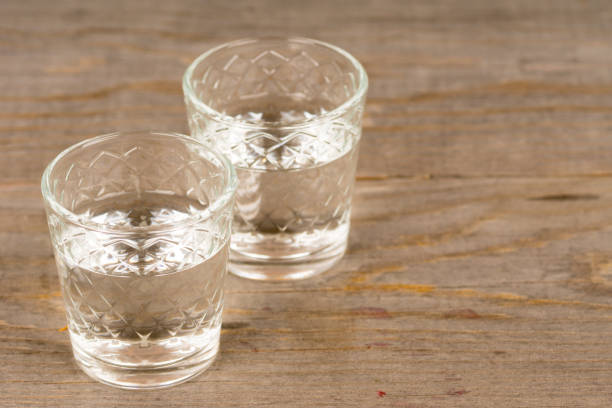 istock vodka in shot glasses on rustic wooden table 1073138434