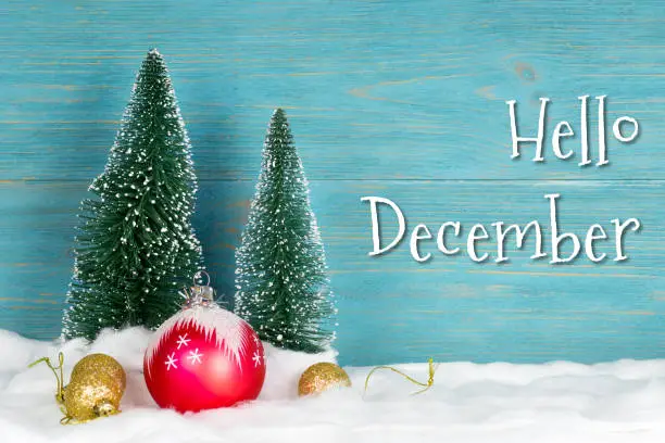 hello december, text over blue wooden planks with xmas decorations