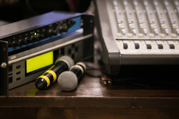 istock music, technology and equipment concept - man at mixing console with computer monitors in sound recording studio 1073145426