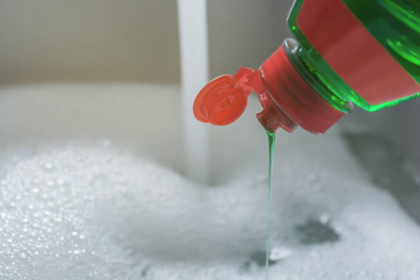 Crockery is washed off in the sink with dishwashing detergent householding dishwashing liquid stock pictures, royalty-free photos & images