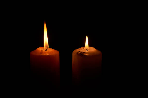 istock Two candlelights in the dark backgroud 1073145700