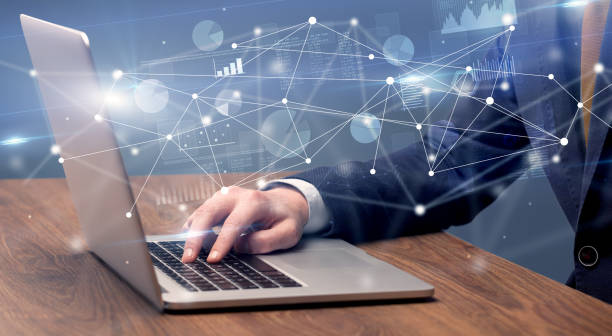 istock Hand typing on laptop with linked report and charts around 1073146104