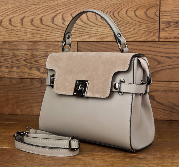 istock beige leather handbag  on wooden background 1073155488