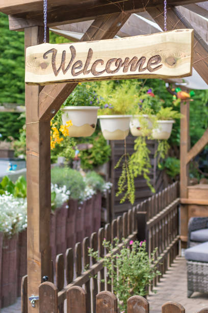 istock Cozy and inviting garden with many plants and welcome sign 1073160114