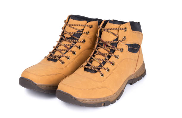 istock Two brown leather hiking boots or shoes isolated on white background. 1073160434