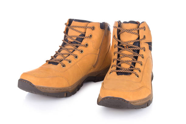 istock Two brown leather hiking boots or shoes isolated on white background. 1073160442