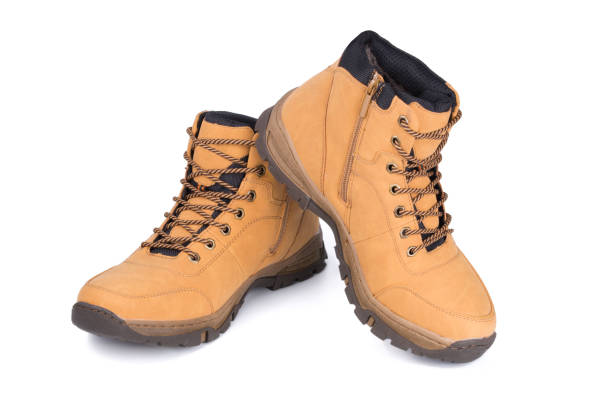 istock Two brown leather hiking boots or shoes isolated on white background. 1073160458