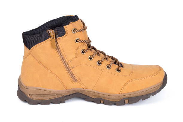 istock One brown leather hiking boot or shoe isolated on white background. 1073160460
