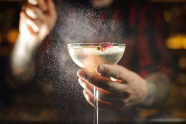 istock Professional bartender spraying on the delicious Twinkle cocktail in the bar 1073163768
