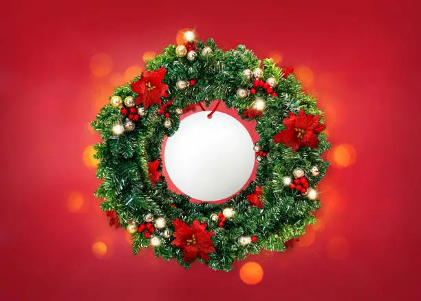 Christmas wreath on color background, with bokeh.