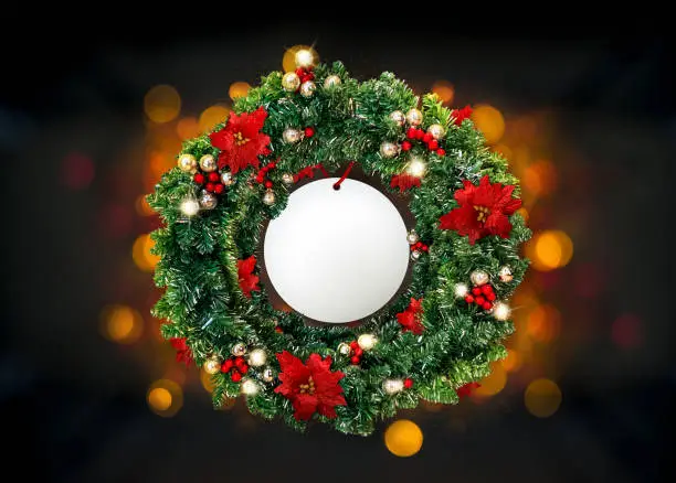 Christmas wreath on color background, with bokeh.