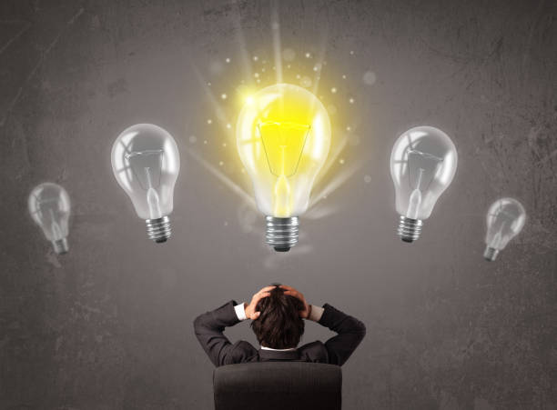 istock Business person having an idea light bulb concept 1073166554