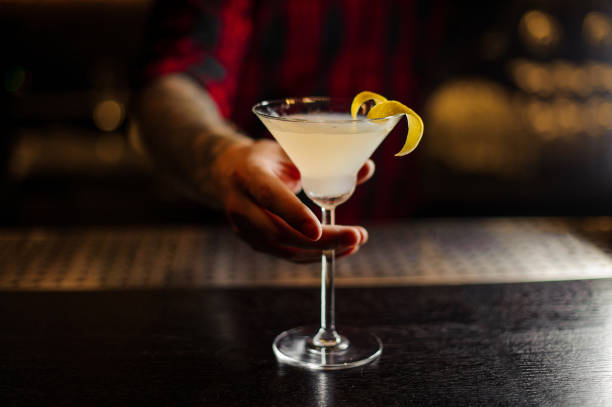 istock Bartender serving a White Lady cocktail decorated with orange zest 1073166590