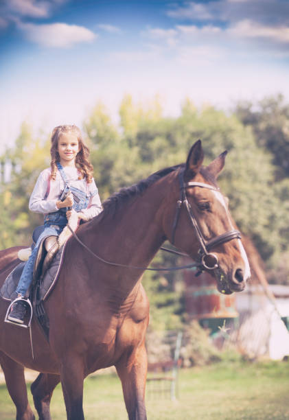 istock Little girl reading horse 1073167608