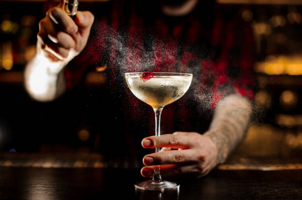 Bartender spraying on a delicious Twinkle cocktail in the bar