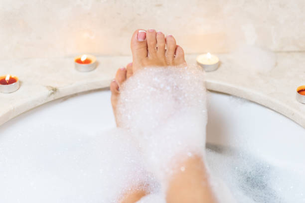istock Woman legs in bath foam. Relaxation in spa. 1073169686