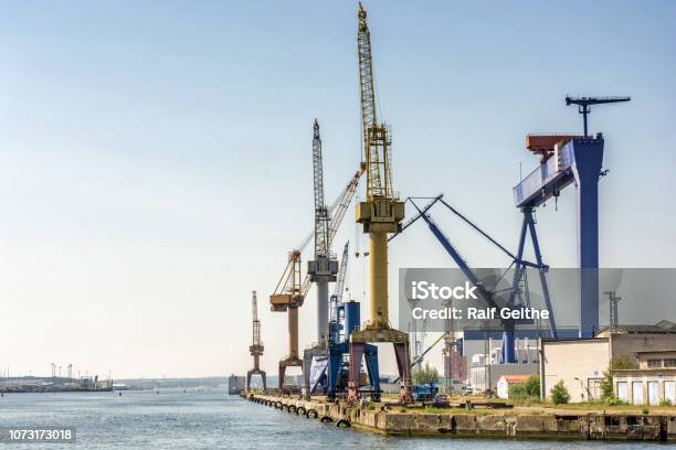 Port Facility With Cranes And Shipyard In The Port Of Rostock Stock Photo - Download Image Now