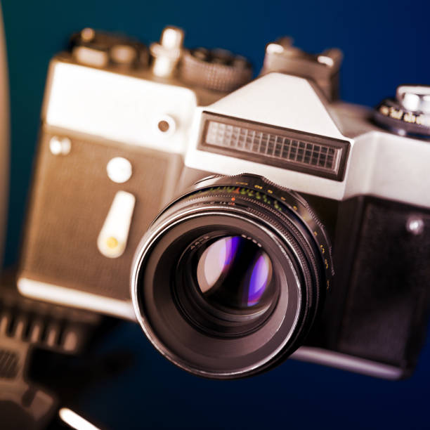 istock Old analog camera in black and silver tones 1073173826