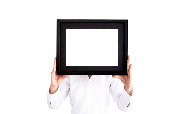 istock Woman on white shirt hand on empty photo frame for text. 1073178828