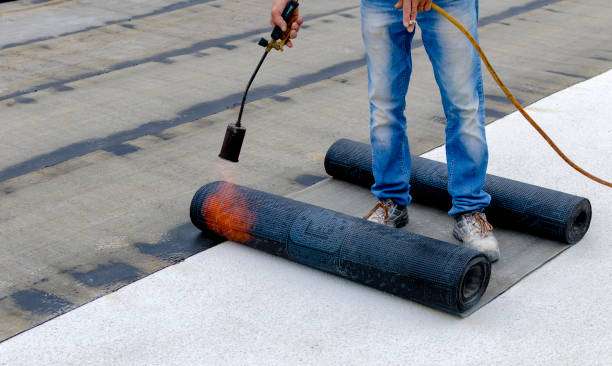 roofer installing rolls of bituminous waterproofing membrane for the waterproofing of a terrace - bitumen felt imagens e fotografias de stock