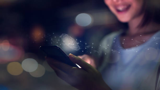 istock Woman's hand is scanning biometric fingerprint for approval to access smartphone. Concept of the danger of using electronic devices is important. 1073181480