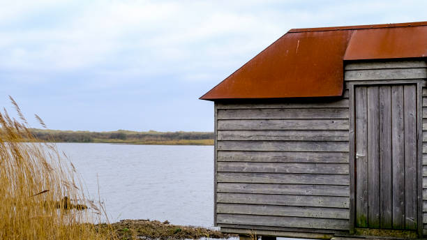 A simple wooden bird observatory in the wetland area just behind the dunes on the island Ameland, the Netherlands