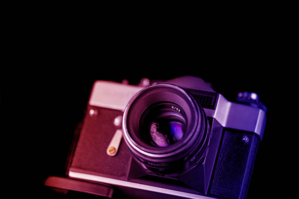 istock Old analog camera in black and silver tones 1073186988