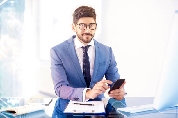 istock Businessman sitting in the office and text messaging 1073196402