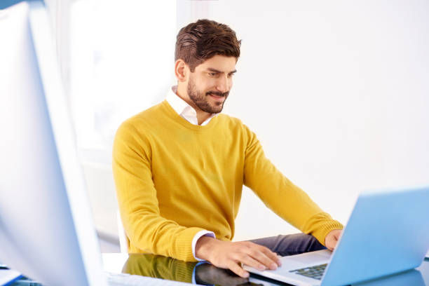 istock Businessman using his laptop while sitting in the office 1073200584