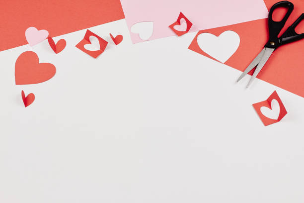 istock Red and pink paper hearts on white background 1073202494