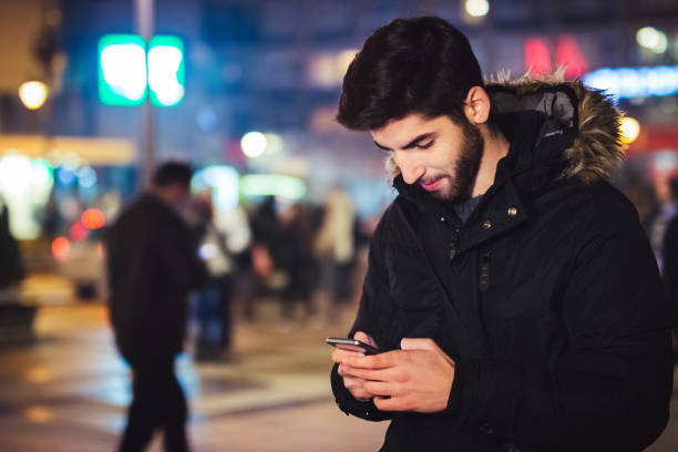 istock young man in  city looking at smart phone and typing 1073203862
