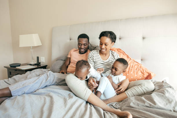 istock Family with 2 children in the bed 1073206496
