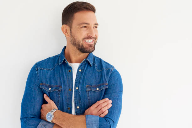 istock Young man with toothy smile studio portrait 1073211392