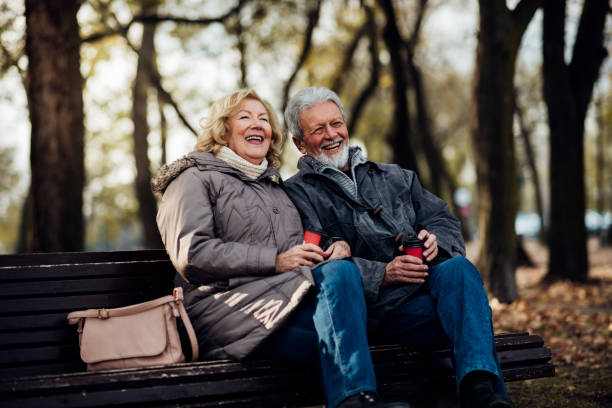 istock Senior couple sitting in a park 1073216198