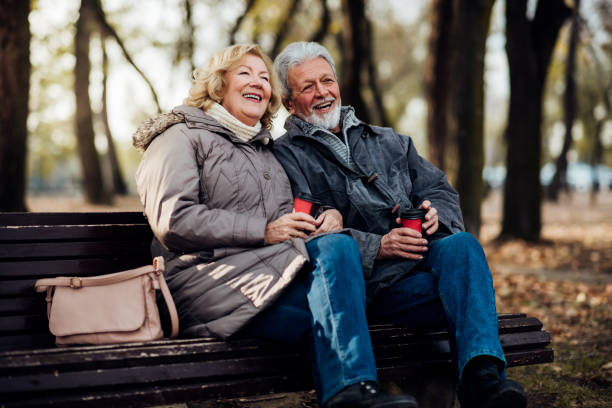 istock Happy senior couple sitting in a park 1073216260