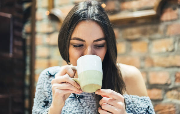 istock Brunette girl in cafe with hot drink 1073217816