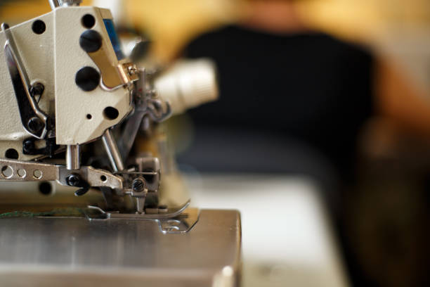 istock closeup details on sewing machine overlock. Workplace seamstress.Tailoring industry 1073222592