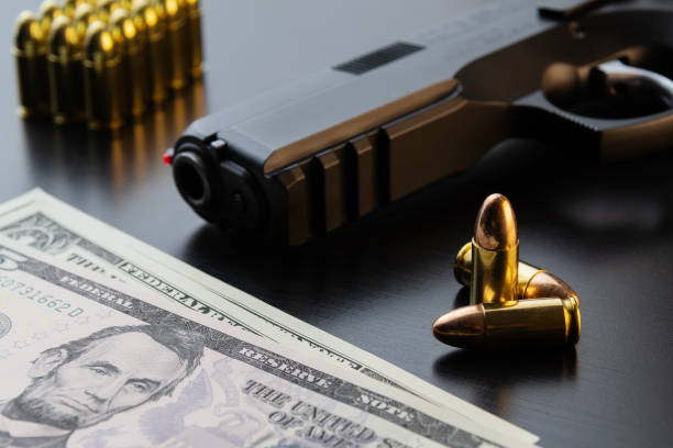 istock Semi-automatic pistol, bullets and dollar banknotes on black background 1073225522