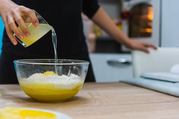 istock Woman pouring lemon juice in a cake dough 1073229640