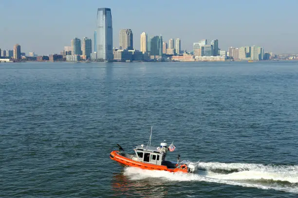 Downtown Manhattan with on the Hudson river and a boat from the U.S. Coast Guard