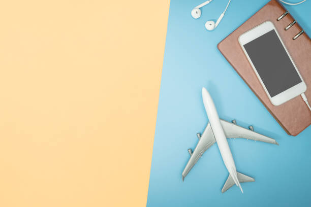 istock Pastel travel gadgets equipment on blue yellow copy space 1073234024