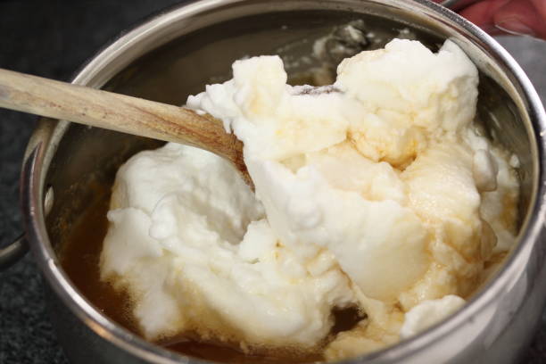istock Mixing whipped egg whites with maple syrup filling 1073234506