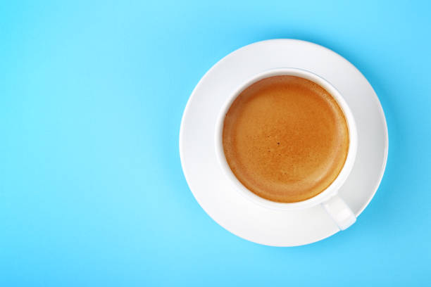 istock Full white cup of espresso coffee on blue 1073241078