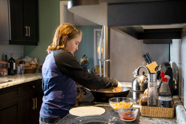 istock A child cooking for himself at home. 1073241284
