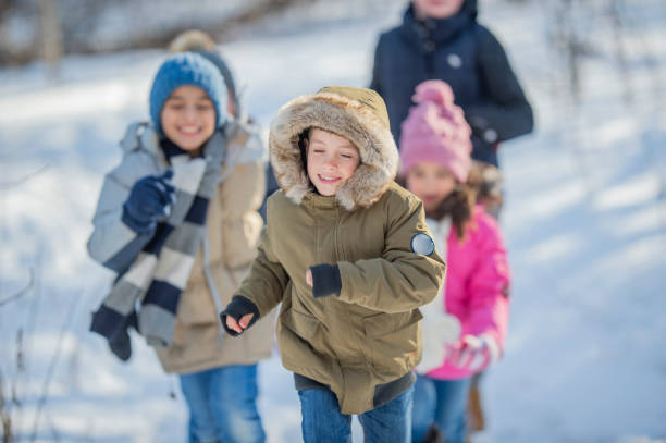 istock Kids running through the snow 1073242108
