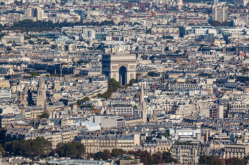paris cityscape with centered arc de triomphe in paris, france.