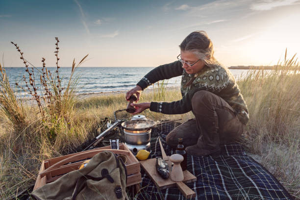 istock Fisherman cooking her catch at the beach 1073245030
