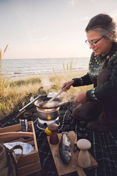 istock Fisherman cooking her catch at the beach 1073245120